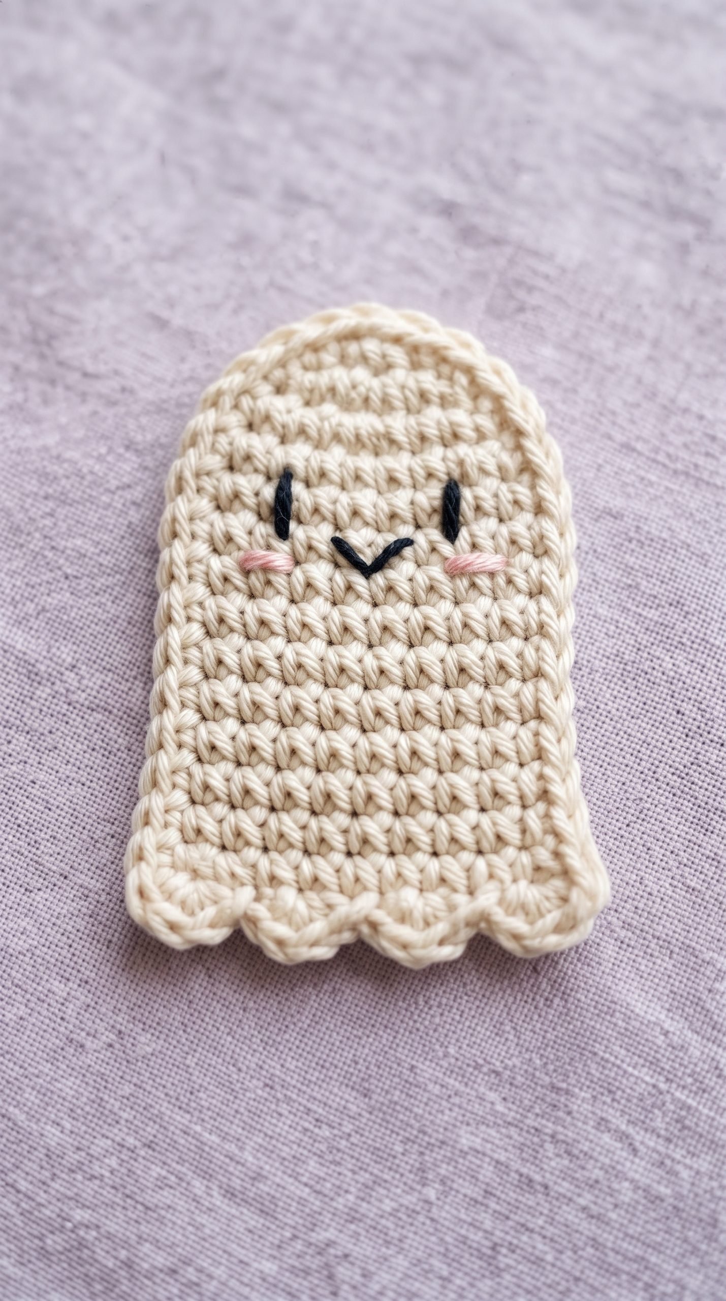 Ivory crochet ghost appliqué with pink cheeks and a scalloped bottom.